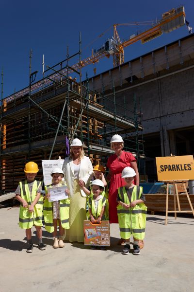 Newcastle Lord Mayor Nuatali Nelmes and NSW Minister for the Hunter Yasmin Catley with the winner and runners-up in the Name the Crane competition at the Newcastle Art Gallery co<em></em>nstruction site.